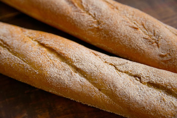 Close-up photo food bread baguette on a old wooden background. Background of freshly baked french bread baguette.