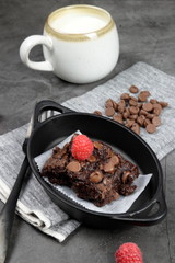 Homemade Chewvy Brownie with Raspberries and a cup of milk