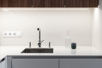 Modern sink with water tap in new contemporary kitchen
