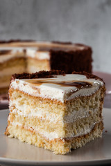 Delicious victoria sponge cake with white cream on plate on table on marble background. Wallpaper for pastry cafe or cafe menu. vertical.