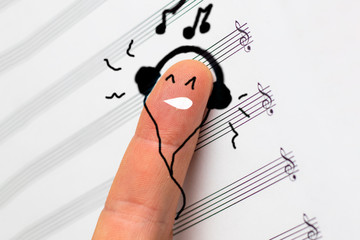 concept. finger lies on notes and listens to music. he is satisfied.