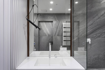 Modern basin with water tap in new contemporary bathroom
