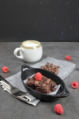 Homemade Chewvy Brownie with Raspberries and a cup of milk