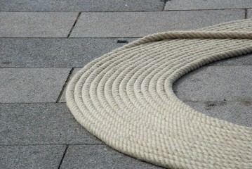 Fototapeta na wymiar rope laid on paving slabs