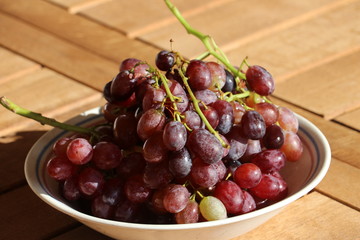 Ripe red grapes from Crete / Greece on wooden table, late autumn harvest