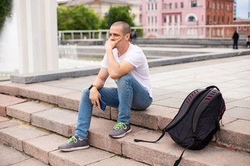 Man thinking about something and sitting on stairs