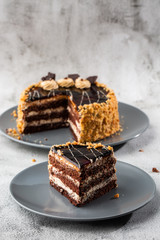 Delicious chocolate cake with white coconut cream on plate on table on marble background. Wallpaper for pastry cafe or cafe menu. vertical.