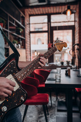 a man plays an electric guitar