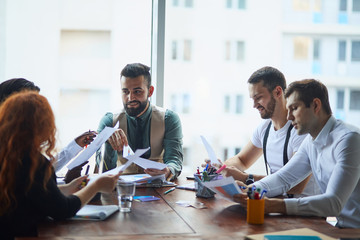 international group of people, business team gathered on table to discuss business ideas, using papers, diagrams. Creative business people