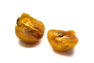 Juicy pieces of ripe persimmon on a white background