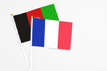 France and Afghanistan stick flags on white background. High quality fabric, miniature national flag. Peaceful global concept.White floor for copy space.