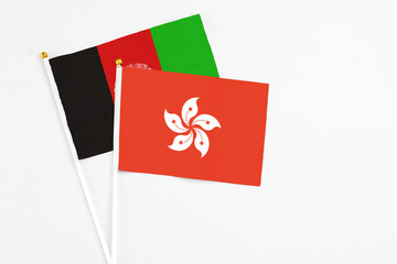 Hong Kong and Afghanistan stick flags on white background. High quality fabric, miniature national flag. Peaceful global concept.White floor for copy space.