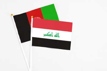 Iraq and Afghanistan stick flags on white background. High quality fabric, miniature national flag. Peaceful global concept.White floor for copy space.