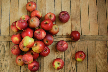 Naklejka na ściany i meble Top view of ripe red juicy apples on wooden background, healthy eating concept, copy space