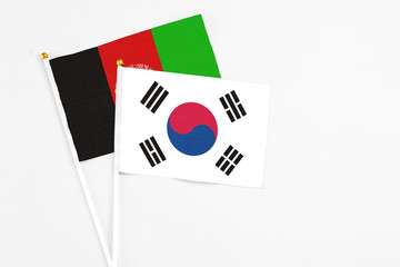 South Korea and Afghanistan stick flags on white background. High quality fabric, miniature national flag. Peaceful global concept.White floor for copy space.