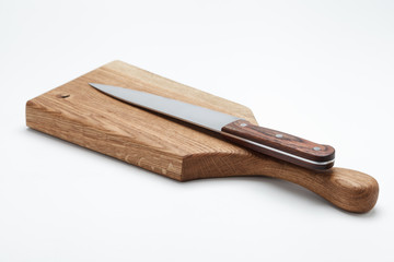 Kitchen Knife Lying On A Cutting Board, White Background