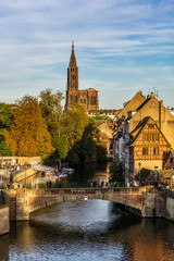 Strasbourg iconic cityscape. Petite France historic medieval district with Ill river and the cathedral in the background. Vertical.