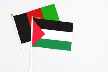 Palestine and Afghanistan stick flags on white background. High quality fabric, miniature national...