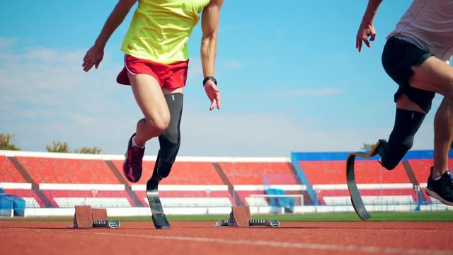 Male paralympians start jogging at the stadium