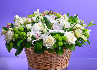 Close up flower bouquet arrangement in wicker basket isolated on white, carnation, rose, orchid,...