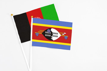 Swaziland and Afghanistan stick flags on white background. High quality fabric, miniature national flag. Peaceful global concept.White floor for copy space.
