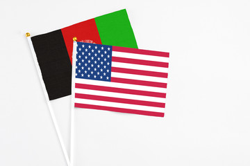United States and Afghanistan stick flags on white background. High quality fabric, miniature national flag. Peaceful global concept.White floor for copy space.