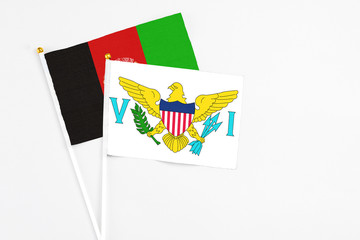 United States Virgin Islands and Afghanistan stick flags on white background. High quality fabric, miniature national flag. Peaceful global concept.White floor for copy space.