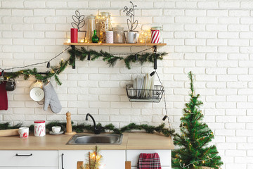 Interior white kitchen with lights and red christmas decorations