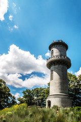 gray stone tower in front of a blue sky