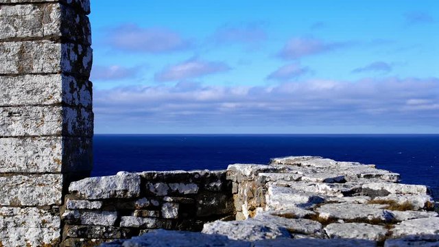 Time Lapse, clouds over ocean with medieval gallow in foreground