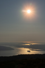 Fototapeta premium Portrait format photo of sunset over Bergen fjord with cruise liner exiting