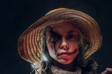 Attractive creative woman has really creepy costume for masquerade, she is posing over dark...