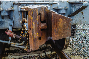 Coupling of railway cars on the tracks. Rusty of train car hook coupler transportation.