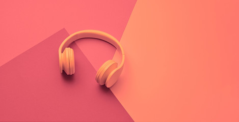 Minimal fashion, Trendy pink neon headphones. Music vibration on geometry background. Hipster DJ accessory Flat lay. Art creative summer vibes, fashionable pop art style. Bright neon color, banner
