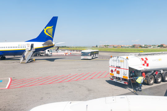 Ciampino, Italy - September 6, 2018: Ryanair airplane domestic European Union flight low-cost cheap airline with in Rome airport and fuel tank carboil company