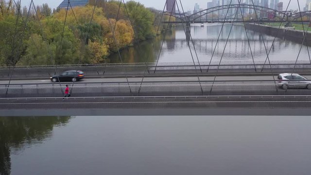 Aerial view with drone Young Sportsman runs on Bringe in Frankfurt. Speed ​​running in cold weather. 11.11.2019 Frankfurt am Main, Germany.