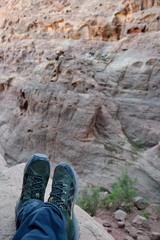 "Trekking shoes on the background of the gorge.".