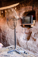 TV and fan in a cave.