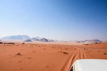 Fototapeta na wymiar SUV driving through the desert.