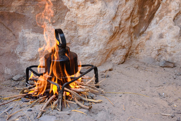 an iron kettle on bonfire