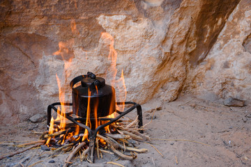 an iron kettle on bonfire