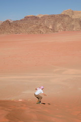 A man riding a sandboarding