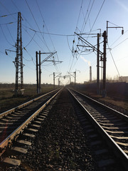 Fototapeta na wymiar Railway tracks and electric transmission lines in the industrial zone.