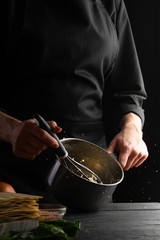 Chef cooks Italian lasagna, stirring sauce, or dressing