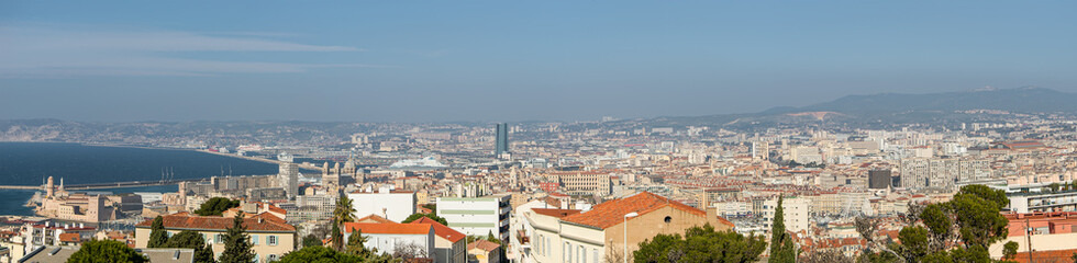 Fototapeta na wymiar Panoramic bird view over modern center, port and suburbs in Marseille at sundown France, sunny day, blue sky