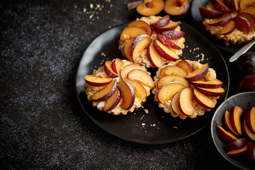 Delicious homemade mini tarts with fresh sliced plum fruit