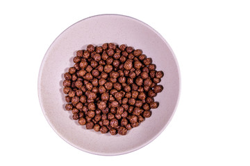 Ceramic plate with chocolate cereal balls isolated on a white background