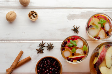 Spiced apple mocktail with mint and cinnamon. wooedn background