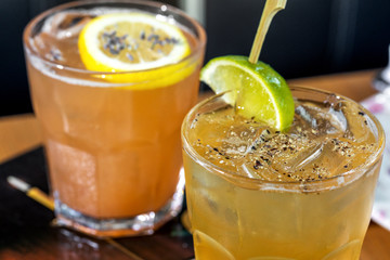 Two lime and lemon fresh alcohol cocktail at a restaurant interior 