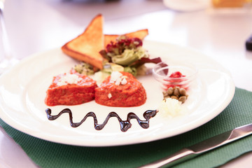 meat with toppings on plate in restaurant